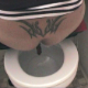 A woman squats over a toilet and shits into it. Over a minute.